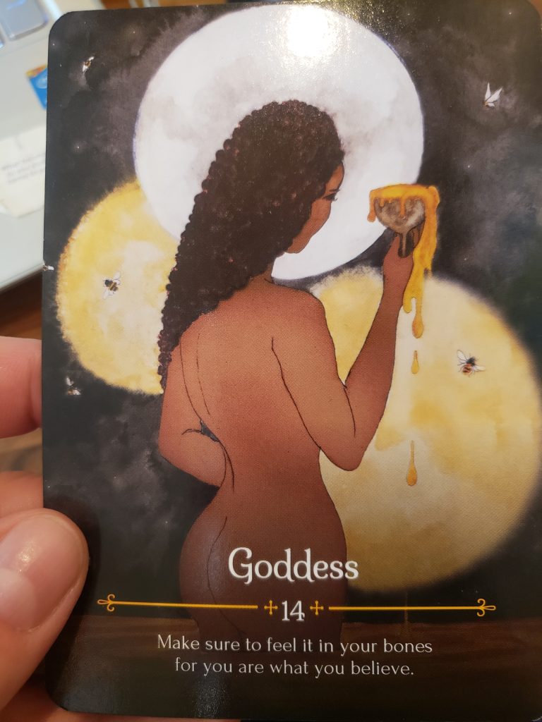 A brown-skinned goddess faces away, toward the moon, holding a cup of honey that runneth over.